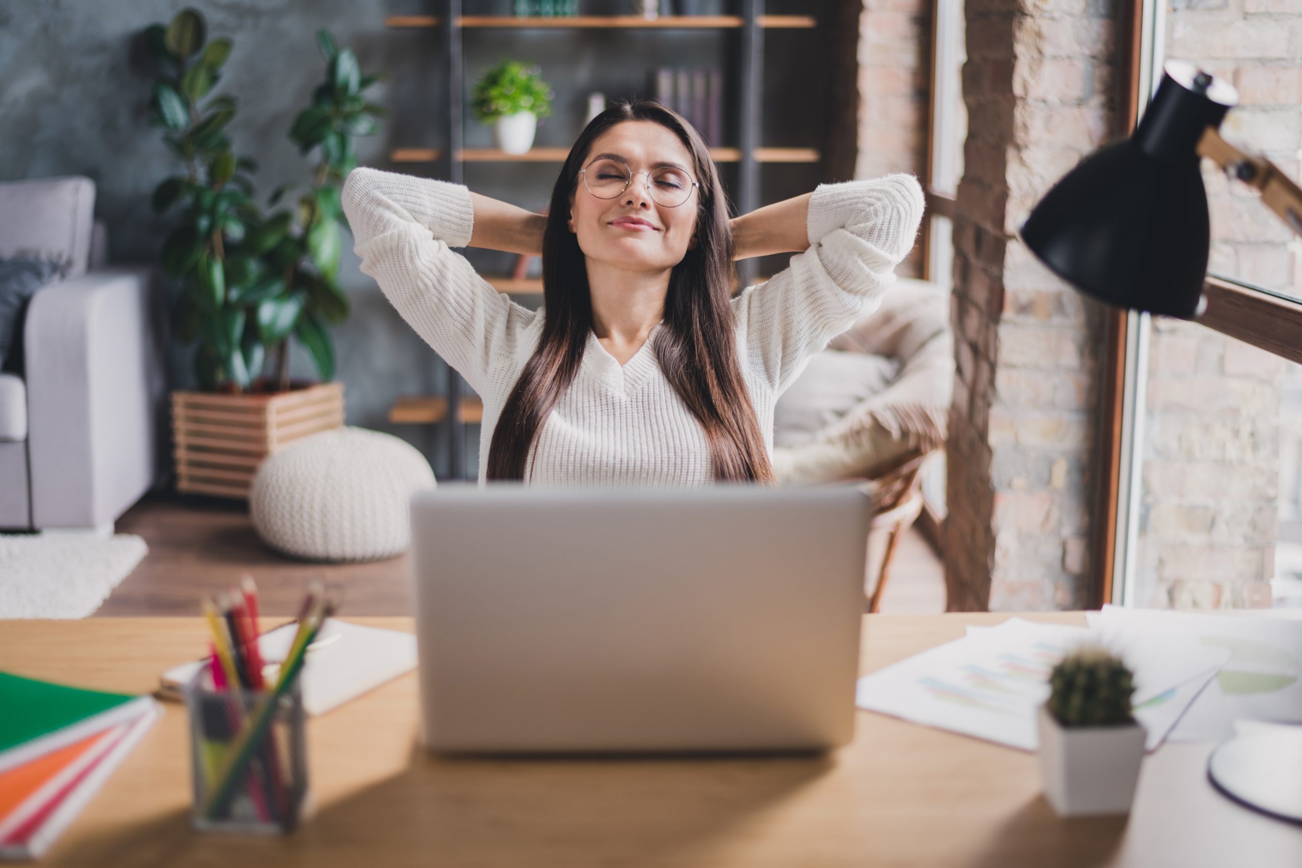 Photo of a smiling radiologists relaxing with closed eyes working from home