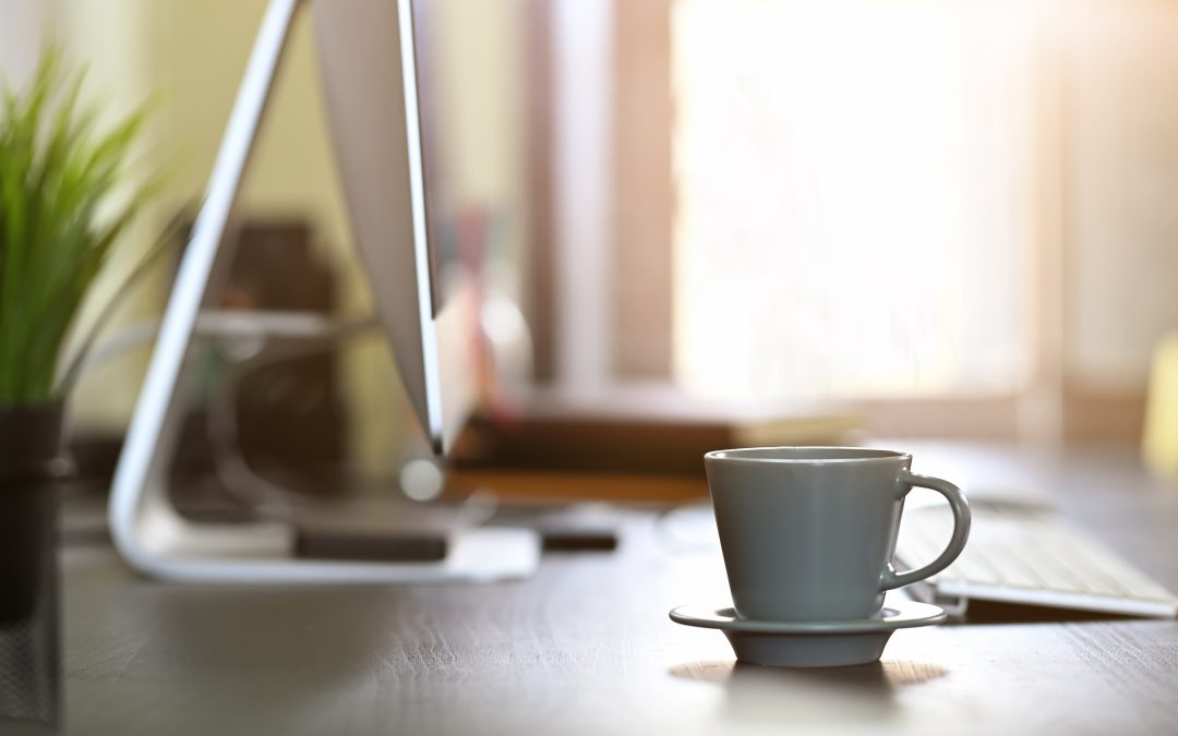 Cup of coffee on a desk in the home of a remote worker